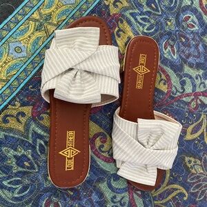 Slides w/ “white sand” canvas band w/ silver sparkle stripes, knotted over toes